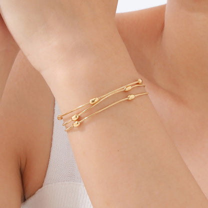 Gold-Plated Multi-Layer Snake Chain Bracelet with Oval Beads